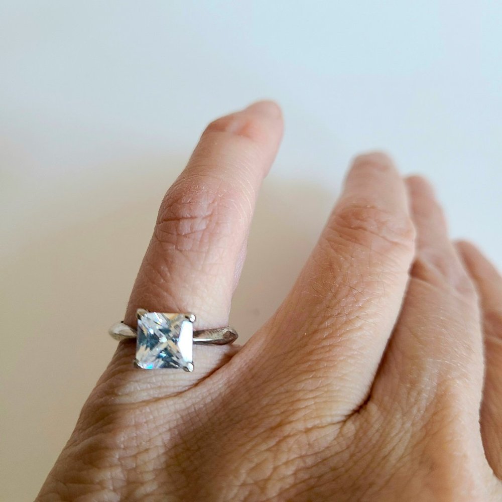 Sterling silver ring with square cubic zirconia stone.